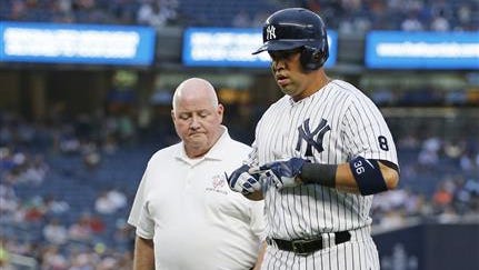 New York Yankees' Carlos Beltran, right, leaves the game with trainer Steve Donohue after an injury while running to first base on a single during the first inning of a baseball game against the Texas Rangers, in New York, Tuesday, June 28, 2016.