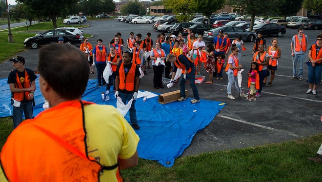 Michael Schroeder, center, talks to the volunteers and where they will be cleaning up in Lebanon. Over 40 people from the local community including Lebanon Valley College and the Palmyra envirothon teams met at the Lebanon Valley YMCA to participate in the 30th annual Ocean Conservancy International Coastal Cleanup Day on Saturday, September 19, 2015. "Really we are cleaning the beach by cleaning up the streets,"  Schroeder, organizer of the Lebanon cleanup said. All the trash in the streets of Lebanon will get into the Quittaphallia Creek which eventually flows into the Atlantic Ocean, Schroeder explained.