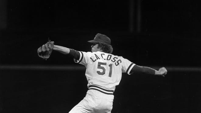 Mike LaCoss of the Reds strides into a first-inning pitch against the St. Louis Cardinals at Riverfront Stadium in April of 1979.