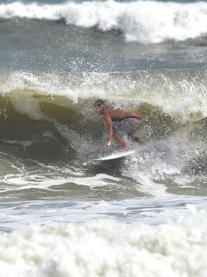 Surfers ride the waves at Fort Pierce Inlet State Park as swells from Hurricane Maria kick up the surf on Monday, Sept. 25, in Fort Pierce. 