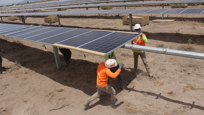 Constructors build the Apache Solar Project outside of Benson.