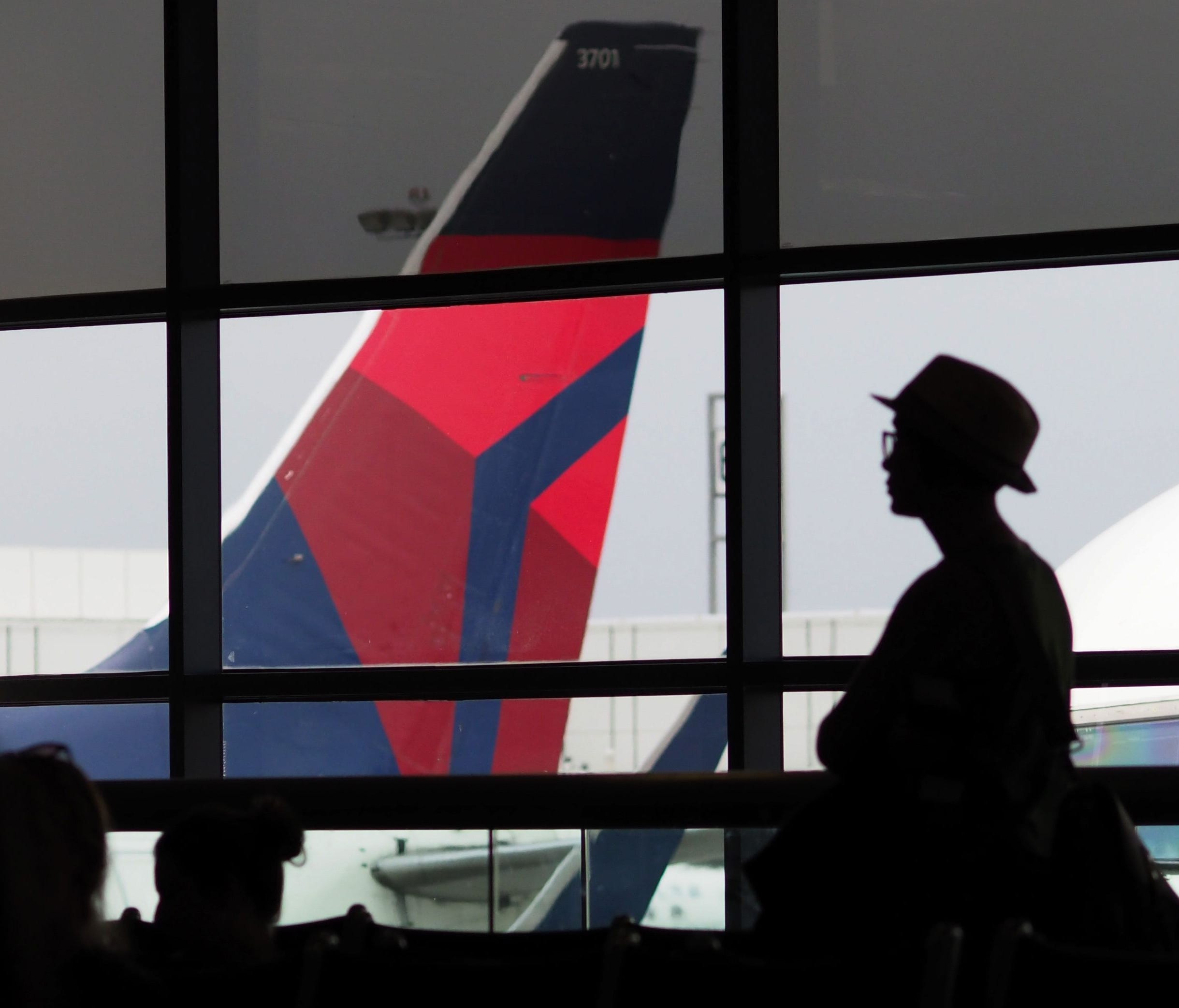 A passengers waits for a Delta Airlines flight in Terminal 5 at Los Angeles International Airport, May 4, 2017 in Los Angeles, Calif.