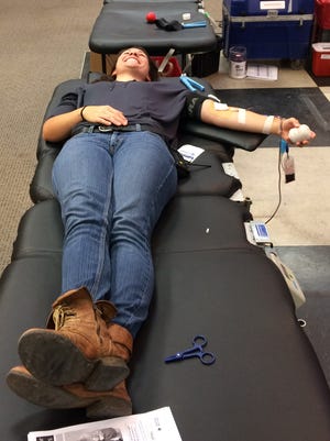 Laura Hayduchok smiled bravely as she gave blood on Oct. 1 at the Shops at Ithaca Mall.