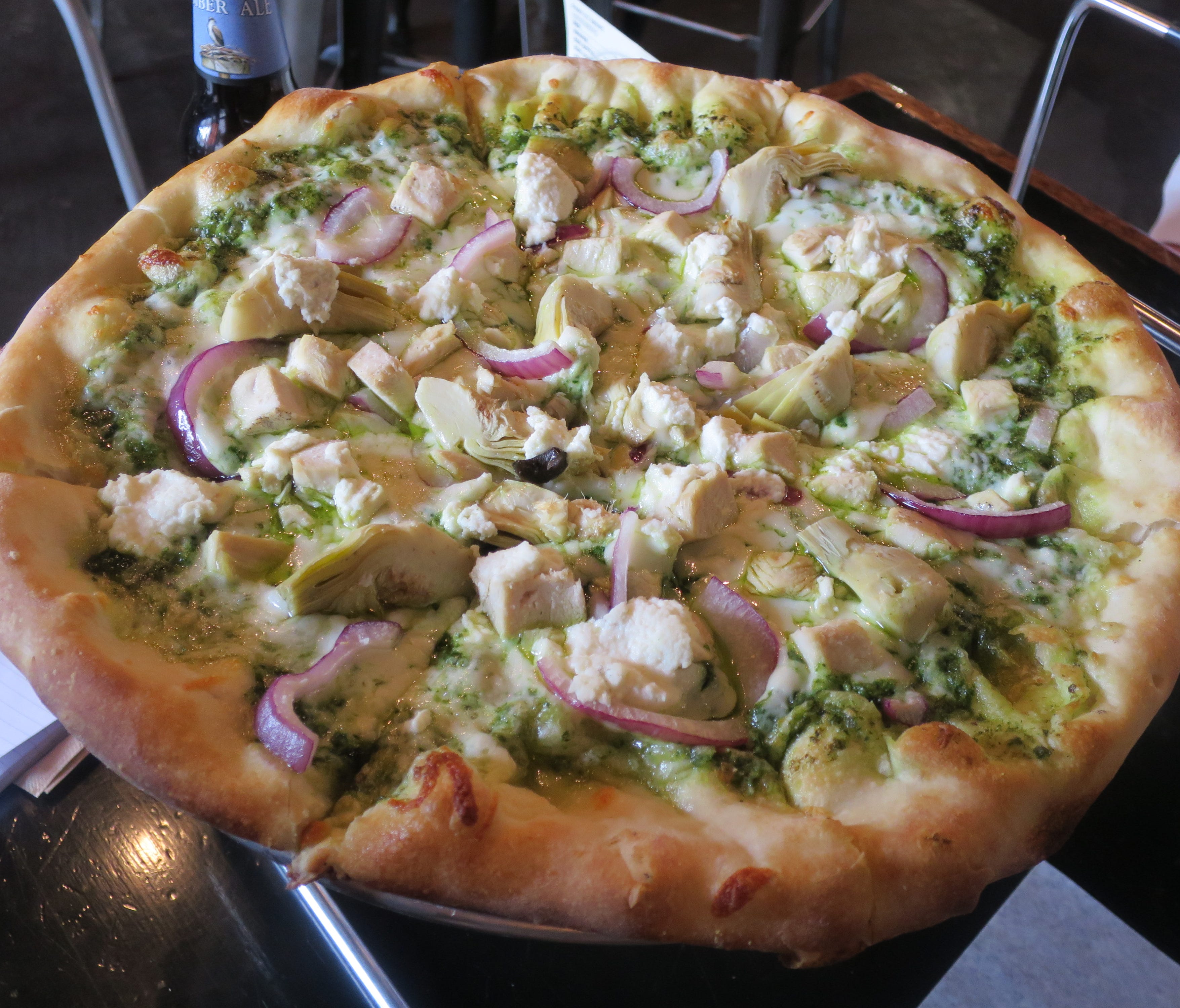 The pizza Guy Fieri made famous on his TV show, 'Diners, Drive-Ins and Dives', is The Funky Chicken, with roasted chicken, artichoke hearts, red onions and ricotta cheese, on a layer of made-from-scratch basil pesto.