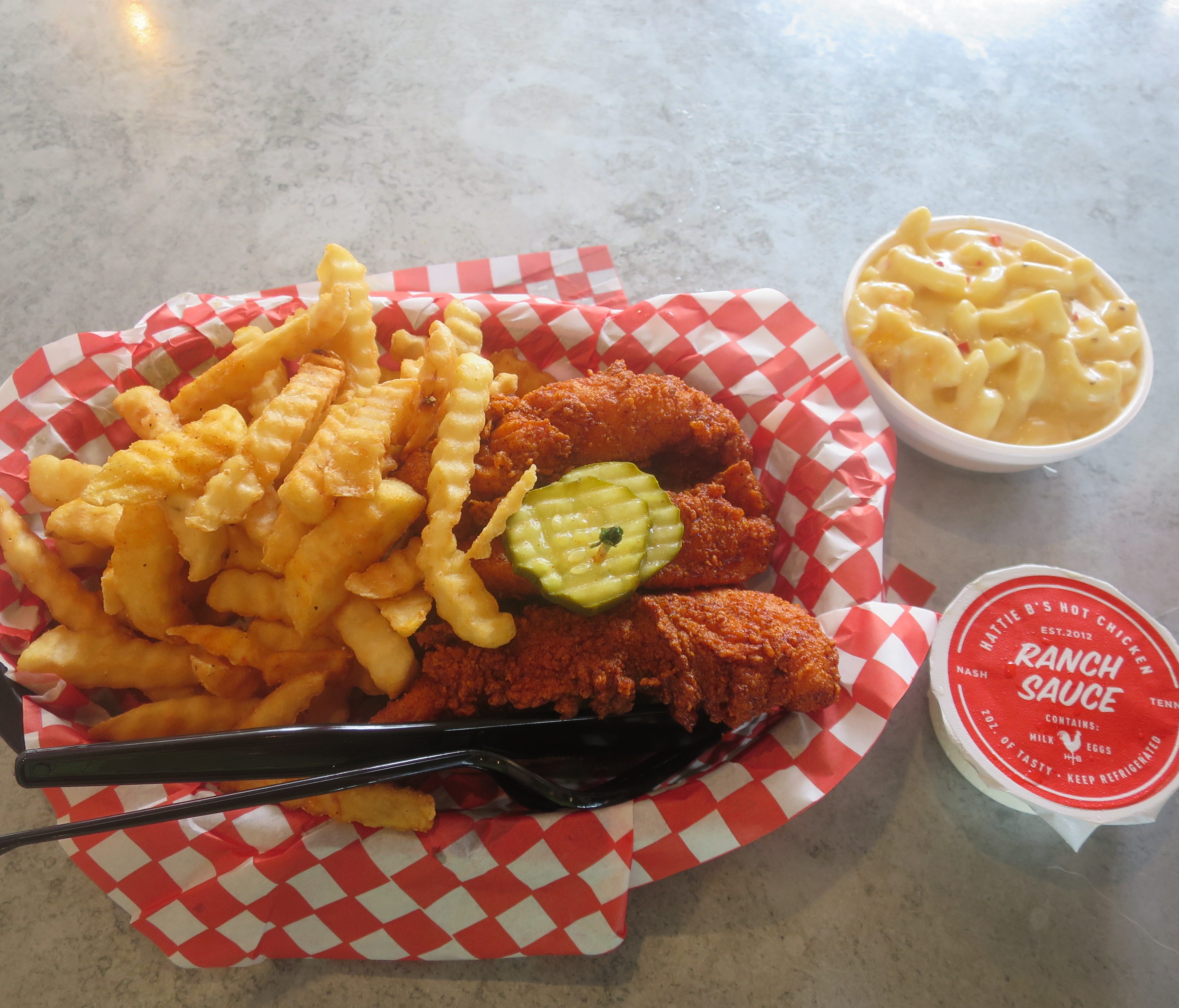 The most popular order at Hattie B's is the hot chicken tenders with mac and cheese, fries and ranch dressing. These are medium heat, which is pretty spicy.