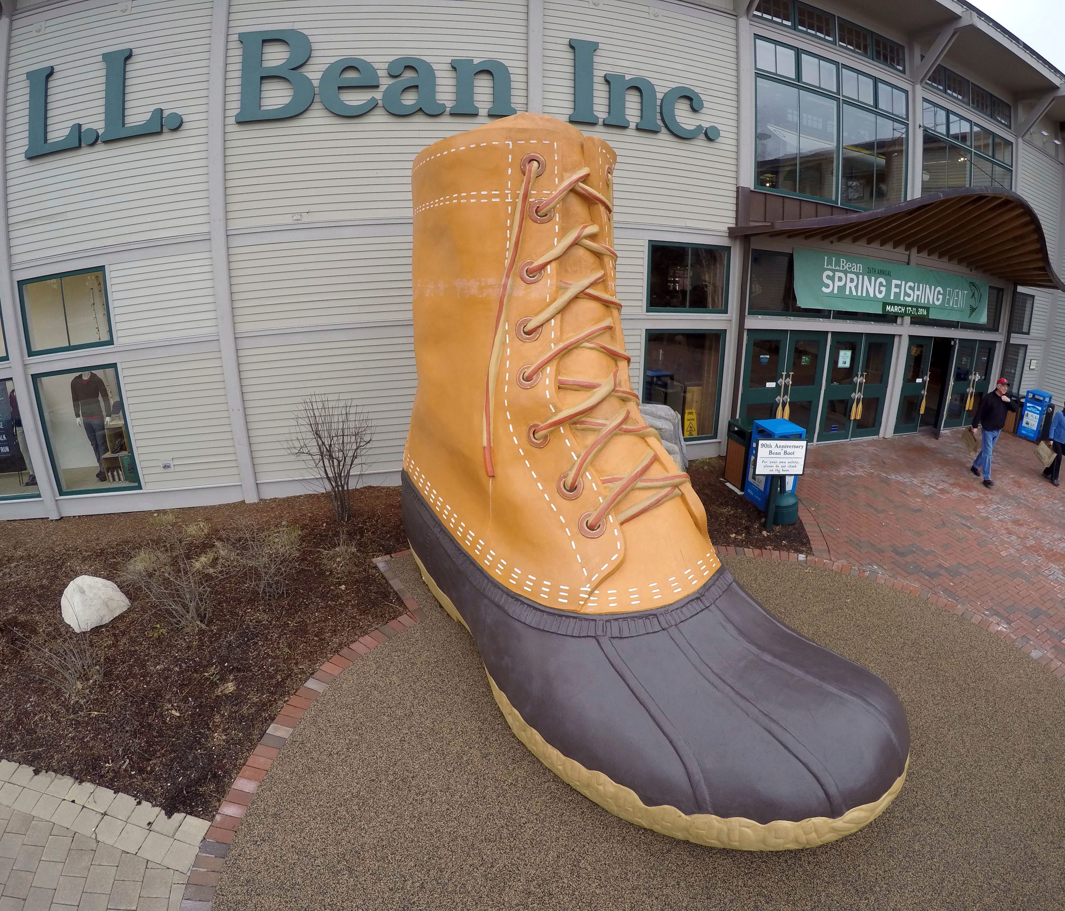 FILE - In this March 16, 2016, file photo, shoppers exit the L.L. Bean retail store in Freeport, Maine.   L.L. Bean is tightening its generous return policy by imposing a one-year limit on most returns to reduce abuse and fraud. Executives say return