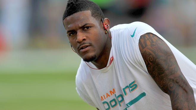Miami Dolphins wide receiver Mike Wallace (11) stretches prior to a game against the Atlanta Falcons at Sun Life Stadium.