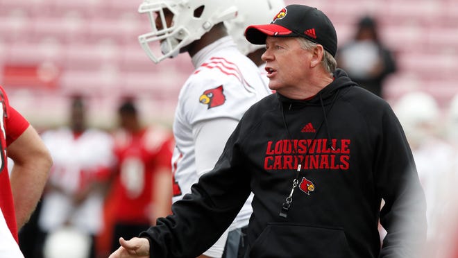 
U of L head coach Bobby Petrino watches his team work out during the first day of spring practice last month at Papa John’s Cardinal Stadium.
