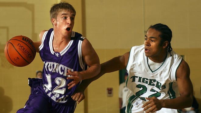 In this 2005 file photo, Muncie Central's Ben Botts carries the ball around in the first half of play at Yorktown.