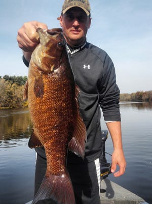 D. C. Everest P.E. teacher Cory Heckel with a monster of a smallmouth bass he caught and released recently on the Wisconsin River