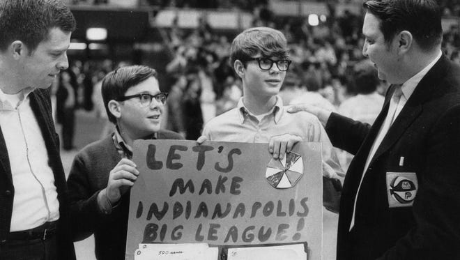 7/7/01 Flashback Two of the originators of a proposed domed sports arena for Indianapolis Bruce Flanagan (left) and Bill York (right) accept a petition on Jan. 31 1970 from Bill Bowman (second from left) and Kevin Cook. The boys gathered 10000 names backing the CAP-A-DOME project spearheaded by Flanagan and York. At the time Houston's Astrodome was the only domed stadium in the country but the men envisioned a domed facility for Downtown Indianapolis as well one that would seat about 50000 spectators and be large enough to host numerous sports including baseball. The ABA Pacers had been playing at the Indiana State Fairgrounds Coliseum since 1967 and the city was divided over building a domed stadium. But due in large part to Flanagan andYork's efforts momentum was built for a new facility. Each man put about $10000 into the project during 1969 and 1970 having plans drawn up and trying to get political backing. But when they saw that financing was not going to materialize the CAP-A-DOME project was dropped. Richard Lugar at that time the mayor of Indianapolis threw his support to a smaller-scale domed stadium which became Market Square Arena. The following year on Oct. 20 1971 groundbreaking ceremonies were held for MSA. It opened in 1974 and closed in 1999. Flanagan who lives in Indianapolis and is in sales says he hates to see MSA go away (tomorrow's implosion) but that "You don't ever progress without change." York who has coordinated the Pacers' stats crew going back to the Coliseum days also handles stats for the Firebirds Fever Ice Colts and the IHSAA. He is Media Center Manager at the Speedway and assists with stats for all other Indy Racing League events. York for whom the Conseco Fieldhouse media center is named says the Pacers played 1062 regular season and playoff games in MSA winning 646 of them. Indianapolis Star Photo / Jerry Clark (Editor?s note: this was originally published on Feb. 2 1970).