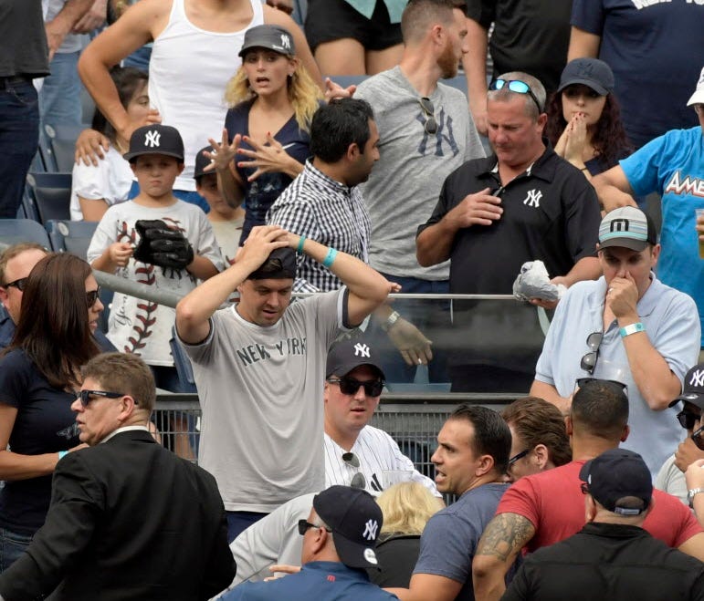 Fans react after a young girl was hit by a line drive during the fifth inning of a game between the New York Yankees and Minnesota Twins.
