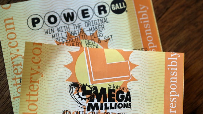 Powerball and Mega Millions lottery tickets are displayed on Jan. 3, 2018, in San Anselmo, Calif. For the first time the Powerball and Mega Millions jackpots are both more than $400 million.