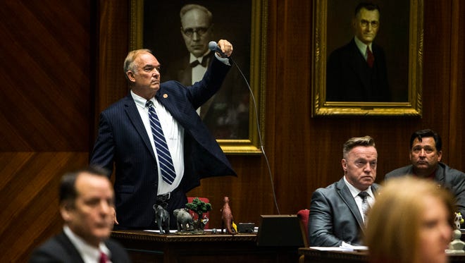 Rep. Don Shooter drops his microphone after giving a statement during a vote on whether to remove him from office on Feb. 1, 2018, at the Arizona House of Representatives chambers in Phoenix.