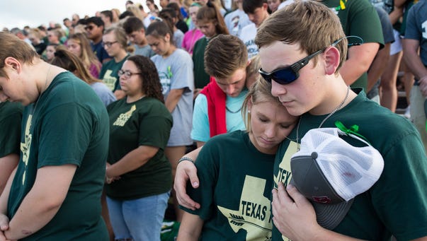 Santa Fe students bow their heads during a moment of