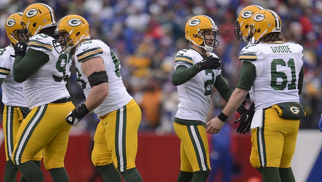 Green Bay Packers kicker Mason Crosby (2) celebrates with his teammates after making a field goal in the first quarter during Sunday's game against the Buffalo Bills at Ralph Wilson Stadium in Orchard Park, N.Y.