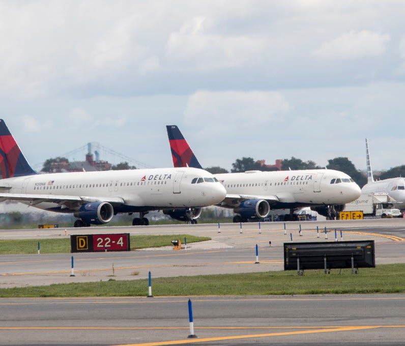 Delta Air Lines planes line the tarmac ahead of a groundbreaking ceremony of the construction on Delta Air Lines $4 billion, 37-gate facility at LaGuardia Airport on Aug. 8, 2017, in the Queens borough of New York.