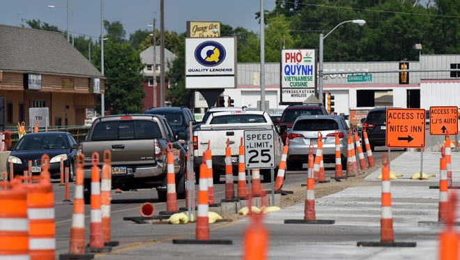 Motorists navigate through the construction on the West 12th Street bridge between Grange and West Avenues on Friday, June 17, 2016.