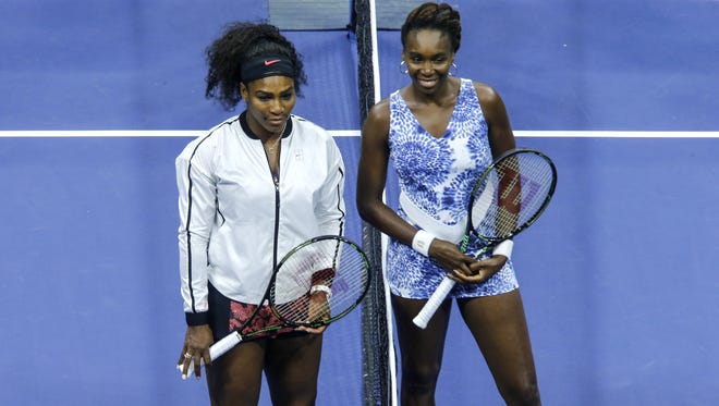 Sisters Serena, left, and Venus Williams pose for a picture before their 2015 US Open Women's Singles Quarterfinals match. at the USTA Billie Jean King National Tennis Center September 8, 2015 in New York.