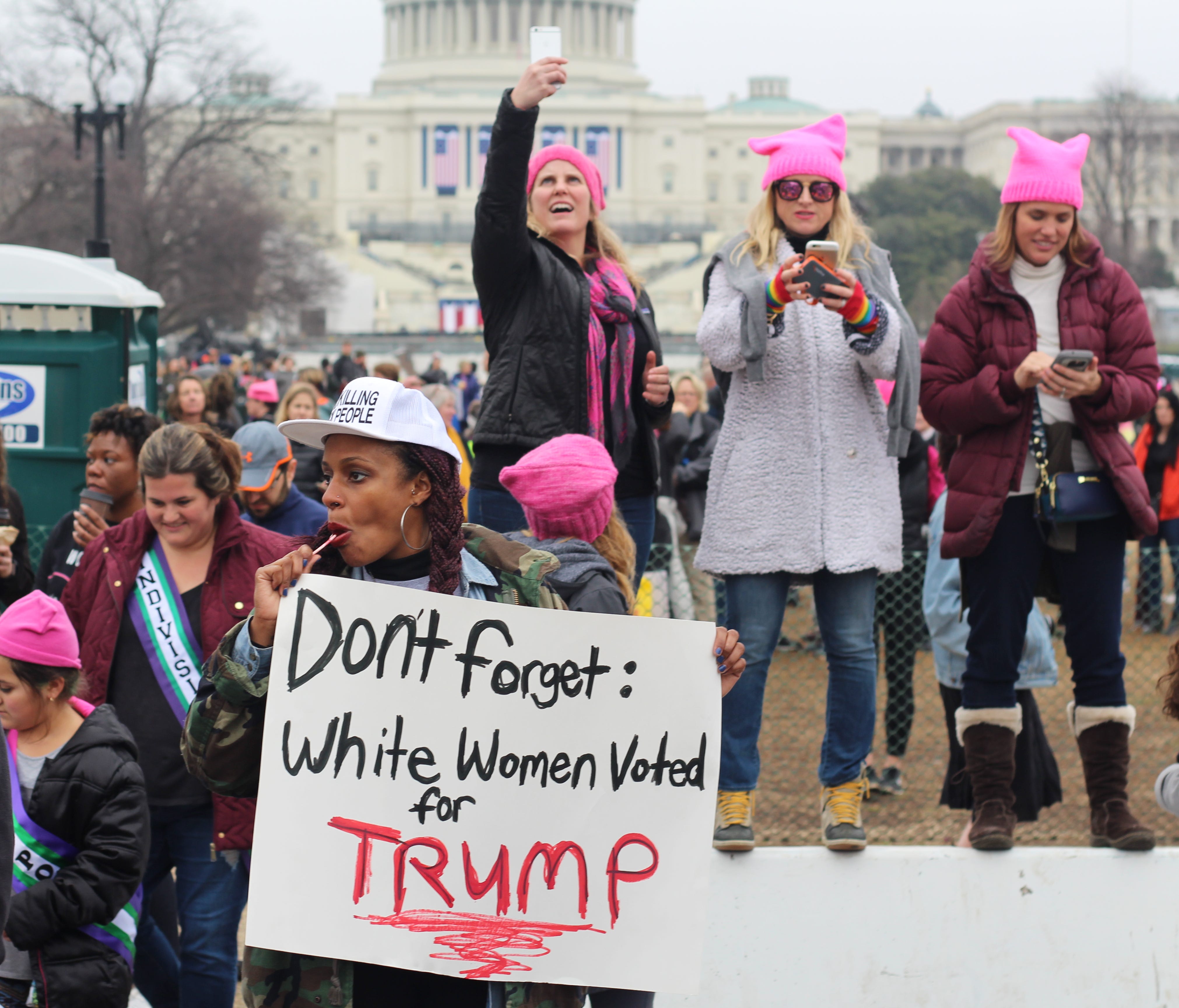 Angela Peoples holds a sign that reads 