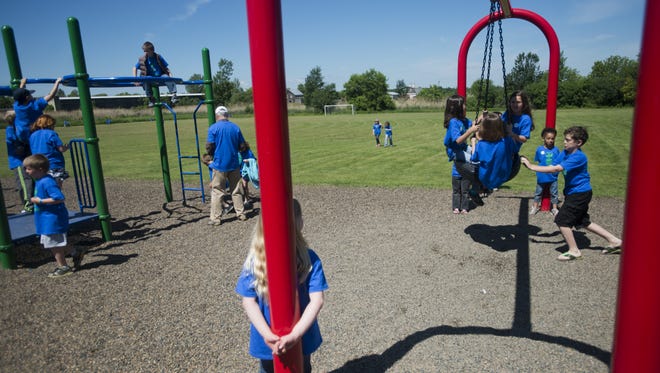 Children at St. Albans City School play on the playground in June 2013.