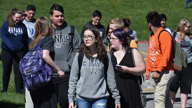 A handful of McQueen High students walked to protest school gun violence on Friday morning April 12, 2018.