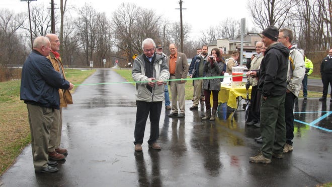 Former Hamburg Township Supervisor Howard Dillman had the honor of cutting the ribbon Dec. 1 to celebrate the completion of improvements to the  Lakelands Trail in the township.