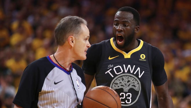 Golden State Warriors' Draymond Green, right, discusses a call with Mike Callahan during the second half in Game 2 of the team's second-round NBA basketball playoff series against the New Orleans Pelicans on Tuesday, May 1, 2018, in Oakland, Calif. (AP Photo/Ben Margot)