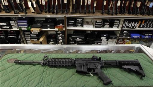 FILE - In this July 26, 2012, file photo, an "AR-15 style" rifle is displayed at the Firing-Line indoor range and gun shop in Aurora, Colo. Baltimore police officers responding to the sound of gunshots near an apartment building fatally shot a man who fired at them with an "AR-15-style" gun, a police spokesman said early Friday, July 15, 2016. No officers were injured in the incident, spokesman T.J. Smith said.