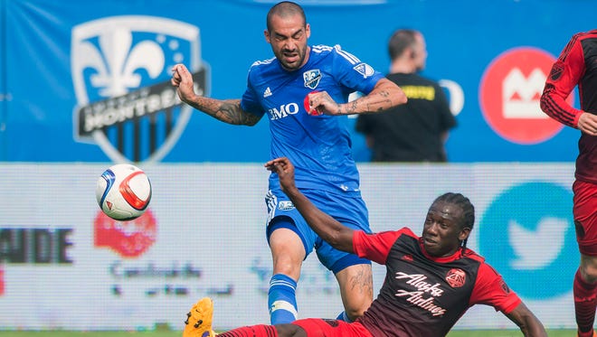 Portland Timbers' Diego Chara, right, slides in on Montreal Impact's Andres Romero during the first half of a soccer game, Saturday, May 9, 2015 in Montreal.