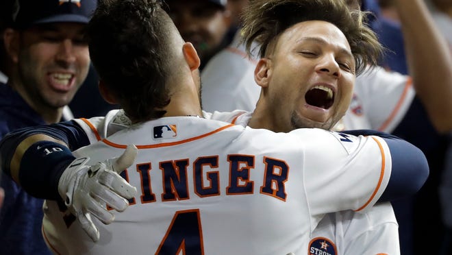 Houston Astros' Yuli Gurriel is congratulated by George Springer after hitting a home run during the second inning of Game 3 of baseball's World Series against the Los Angeles Dodgers Friday, Oct. 27, 2017, in Houston. (AP Photo/David J. Phillip)