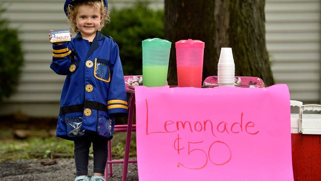 Three-year-old Hannah Pasley of Kansas City, North, dreams of becoming a police officer when she grows up. Hannah sold lemonade over the weekend to earn money to buy herself a police uniform -- and succeeded. After officers from various law enforcement agencies heard about Hannah, they stopped by to buy lemonade and meet her Saturday. (Jill Toyoshiba/Kansas City Star/TNS)