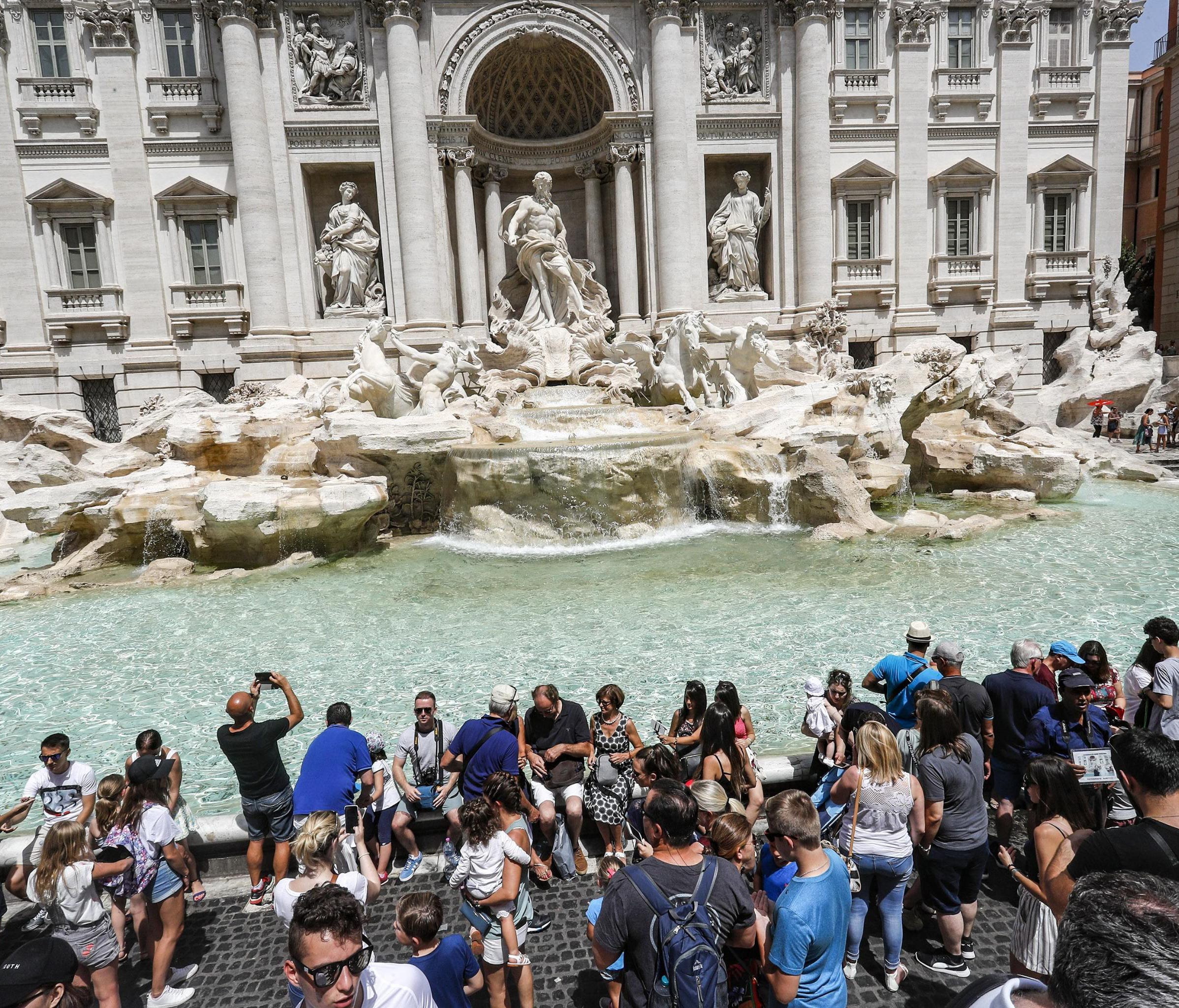 Rome is the 22nd top up-and-coming trending summer international destination for the month of July, based on the latest booking data from American Express Travel. Tourists are seen here next to the world-famous Trevi Fountain during a hot day in July