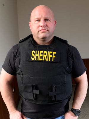 Sandusky County Sheriff Kyle Overmyer shows  new Kevlar body armor. Overmyer has been indicted on 43 counts.