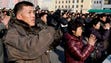 North Koreans watch a   broadcast on a video screen