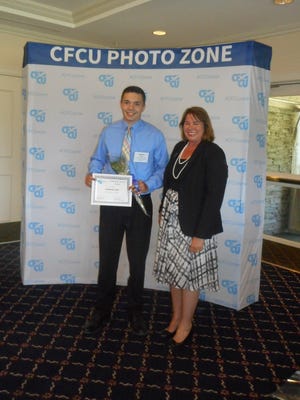 Nathan Ossit received the CFCU Community Service Award from Lisa Whitaker, President and CEO of CFCU.