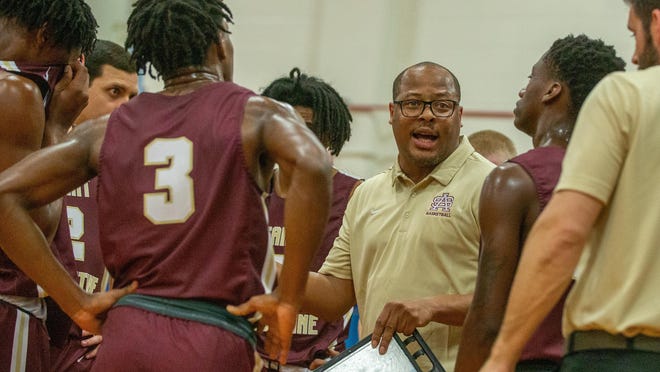 St. Augustine basketball coach Quinterrance Cooper organizes the Yellow Jackets during a Tuesday, Feb. 25, 2020 Region 1-5A semifinal against Lee.  On Monday, June 22 Cooper suspended the Yellow Jackets' offseason program after the parents of a player tested positive for COVID-19.