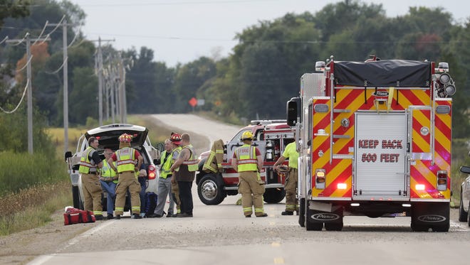 Officials investigate a one-vehicle crash Tuesday, Sept. 13, 2016, in the Town of Hortonia, Wisconsin.