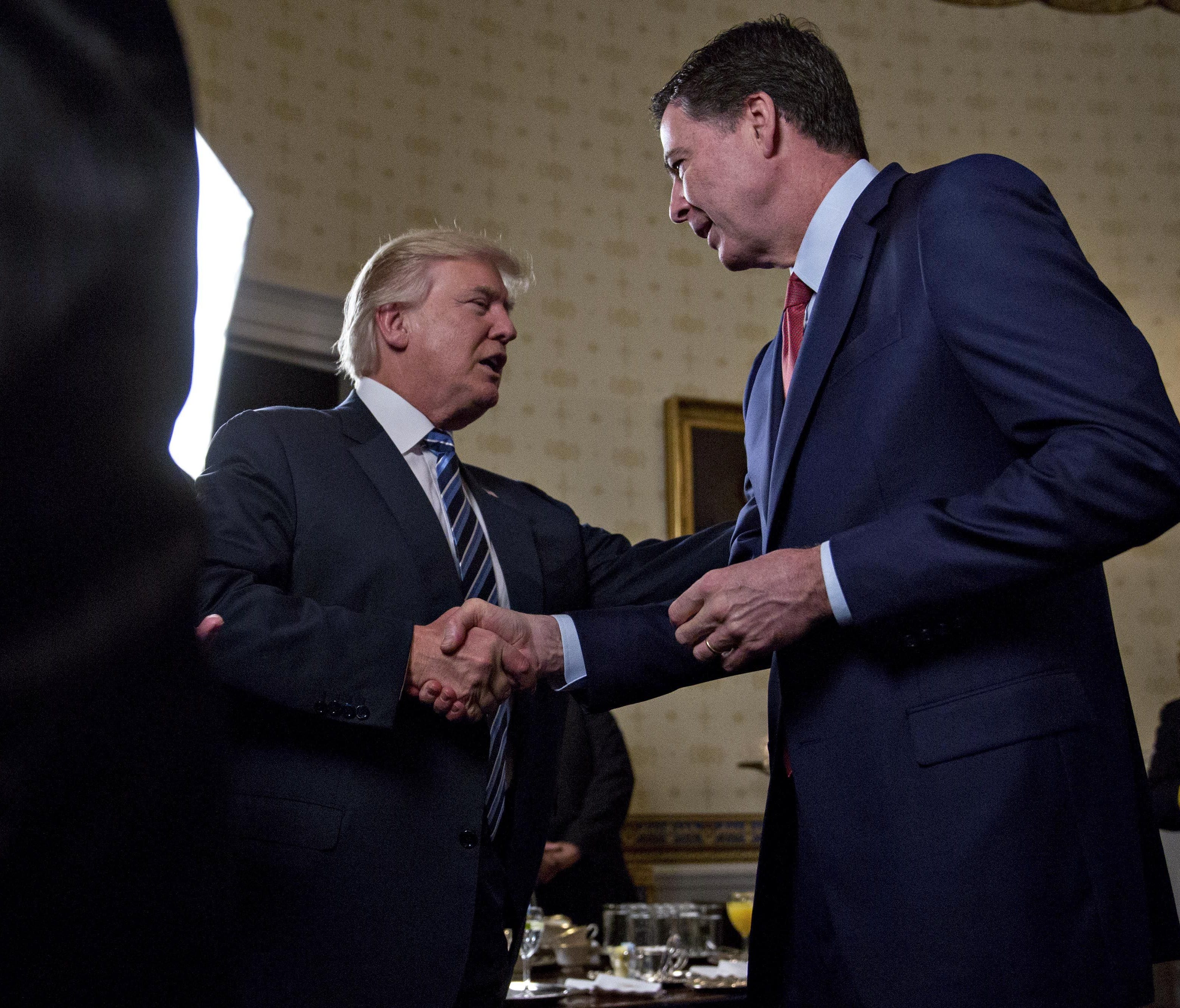 President Trump shakes hands with FBI Director James Comey during an Inaugural Law Enforcement Officers and First Responders Reception at the White House on Jan. 22, 2017.