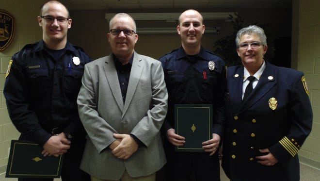 New firefighters Kody Gazdag (left) and Patrick Renner (second from right) are joined by Garden City Mayor Robert Walker and Fire Chief Catherine Harman.
