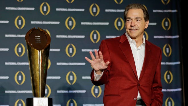 In this Jan. 12, 2016, file photo, Alabama head coach Nick Saban poses with the championship trophy during a news conference for the NCAA college football playoff championship in Scottsdale, Ariz.  Saban is one national title away from matching Bear Bryant's record and, with his 65th birthday coming up on Halloween, shows no signs of slowing down.
