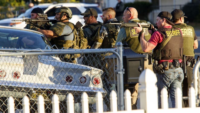 Law enforcement officers search for the suspects of a mass shooting  Dec. 2, 2015 in San Bernardino, Calif.
