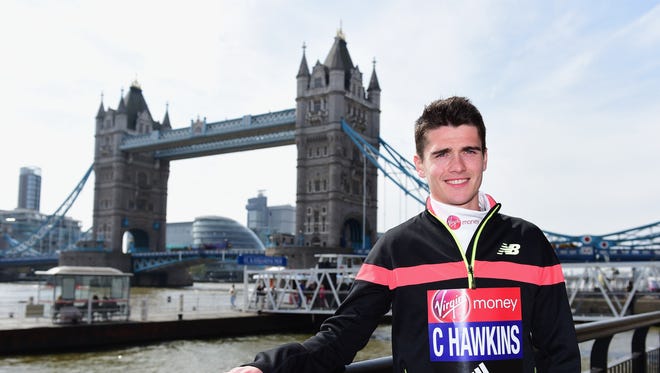 British runner Callum Hawkins poses in front of Tower Bridge ahead of the Virgin Money London Marathon at The Tower Hotel on April 21, 2016 in London. Callum Hawkins is aiming for selection for the 2016 Olympic Games in Rio.