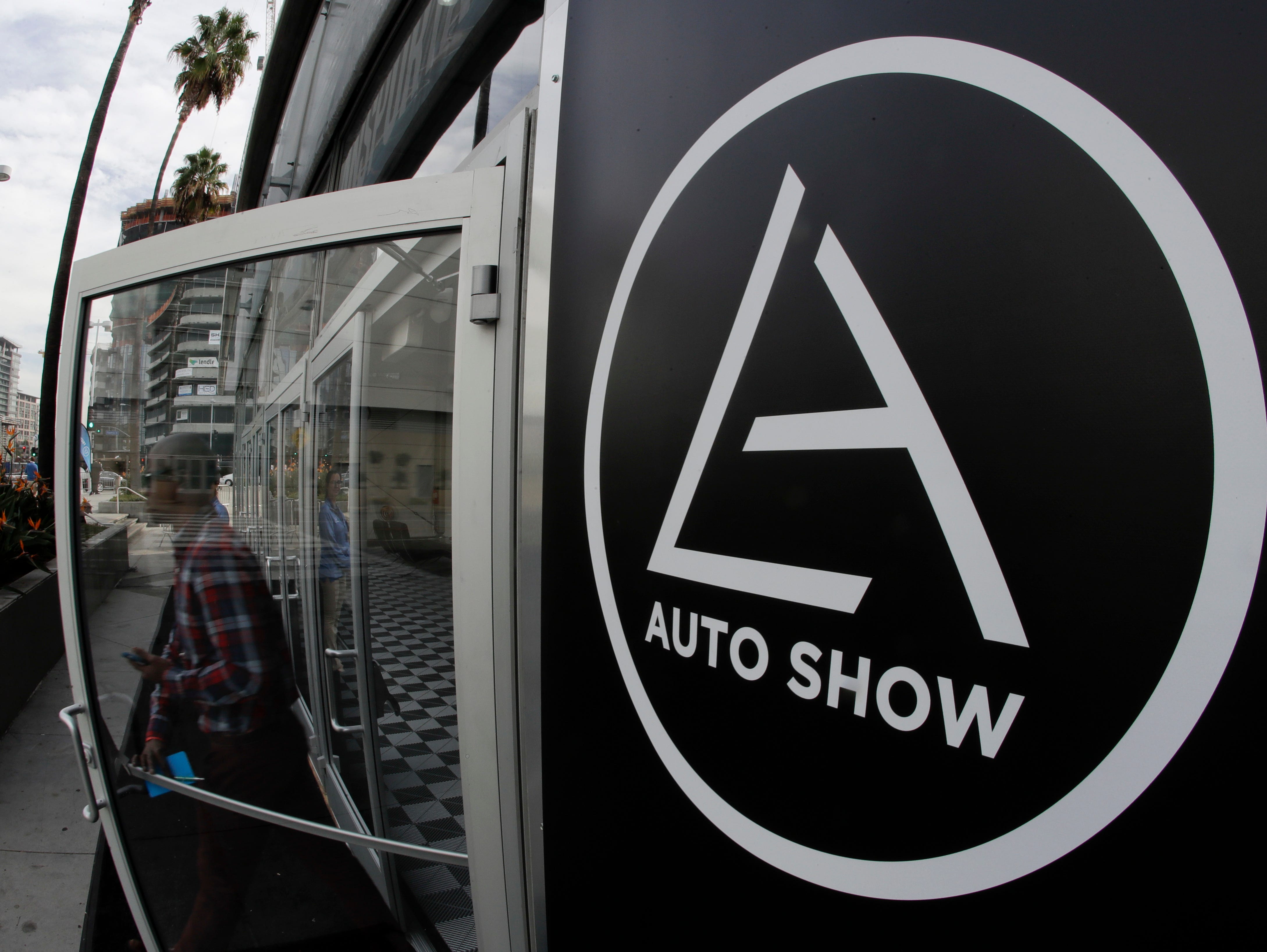 A visitor leaves a display during Los Angeles Auto Show at the convention center in Los Angeles.