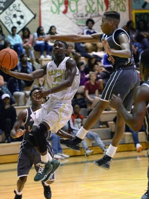 Toronco Loston of Captain Shreve shoots past Plain Dealing's Tyjuan Thomas for a layup in the last home game of his high school career last December.