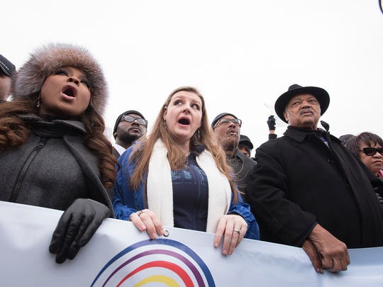 Flint resident and community activist Melissa Mays, center, the Rev. Jesse Jackson and Phaedra Parks during the march.