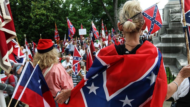 Attendees of a pro-Confederate flag rally listen to speakers on the steps of the Alabama state capitol building on Saturday, June 27, 2015, in Montgomery, Ala. The rally was held by locals and members of several Southern heritage organizations who oppose the recent removal of Confederate flags from a monument at the capitol honoring Confederate Civil War soldiers.