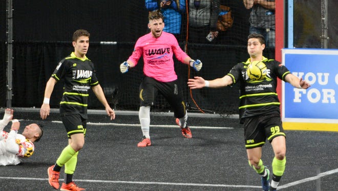 Milwaukee Wave goalkeeper Josh Lemos apreciates the help from forward Andre Hayne (right) in stopping a Baltimore Blast attack.