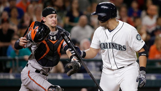 Baltimore Orioles catcher Caleb Joseph, left, reaches to tag Seattle Mariners' Jesus Montero after Montero struck out swinging to end the baseball game in the ninth inning, Monday, Aug. 10, 2015, in Seattle. The Orioles won 3-2.