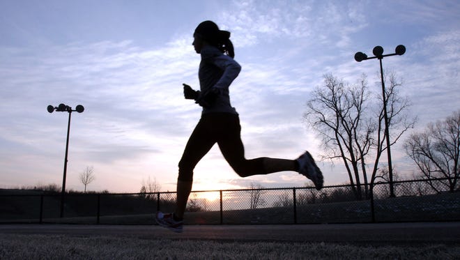As the sun starts to come up Desiree Davila, 28 nears the end of her training run on a track at a school in Rochester Hills on Saturday, morning Dec. 3, 2011. Davila is one a several runners from the Rochester Hills based Hansons-Brooks Distance Project running team. The group were in their last week of training at this time before they were going to finish training in Orlando in preparation for the US Olympic men's and women's marathon trails on Jan. 14 in Houston, Texas.